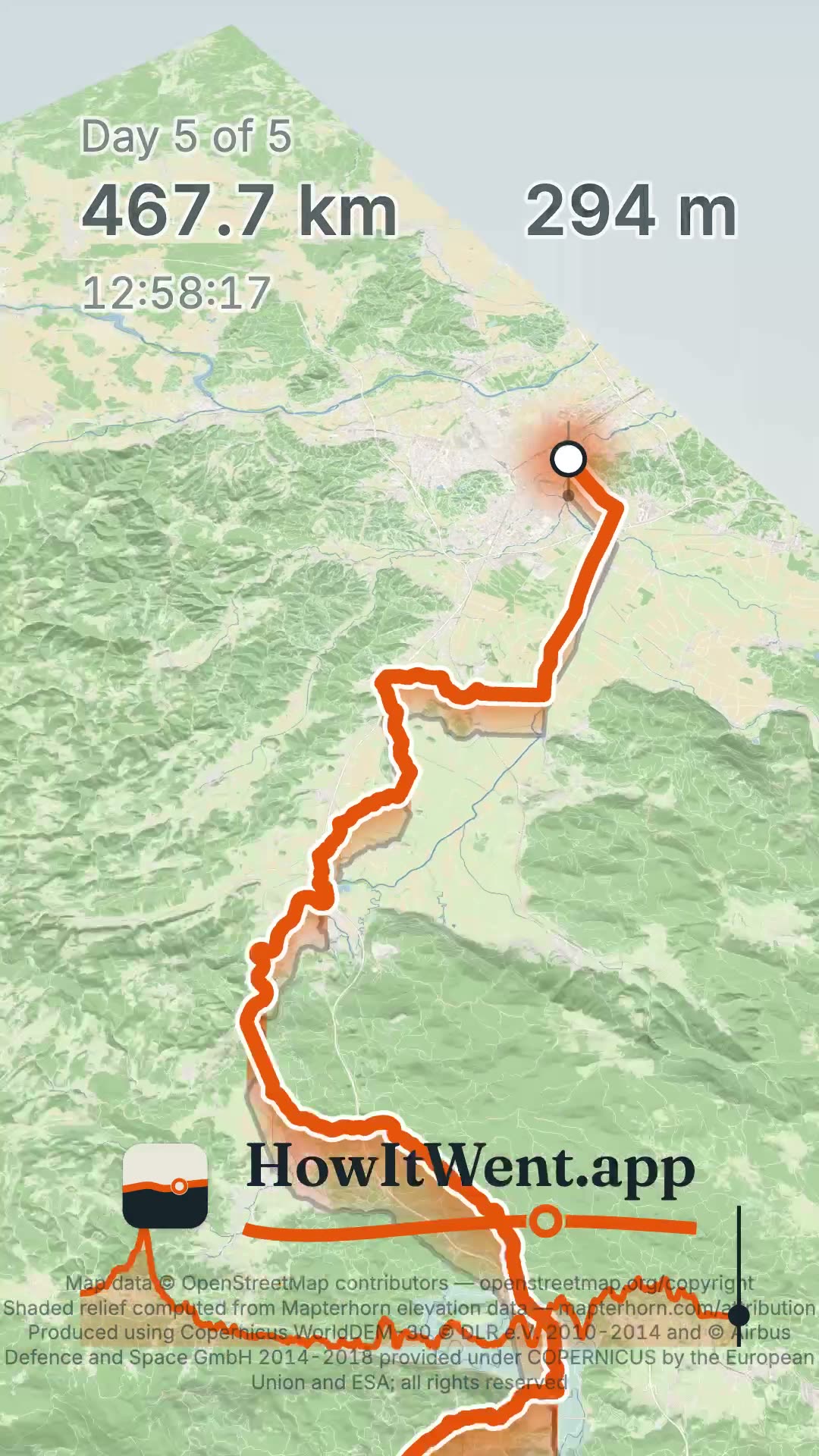 A frame of a vertical film on day 5 of 5, at 467.7 km, as the camera pulls back over the last day's route into Ljubljana. The map and its shaded hills are clear from the top of the frame to the bottom.