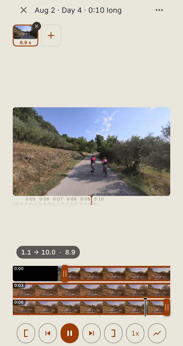 A ten-second clip of two riders on a road between olive trees, playing on an iPhone from the Moments step. The playhead is just past 0:09 in the kept stretch from 1.1 to 10.0 seconds, the filmstrip below shows the whole clip in three rows, and the play button shows pause. Taken September 19, 2026.